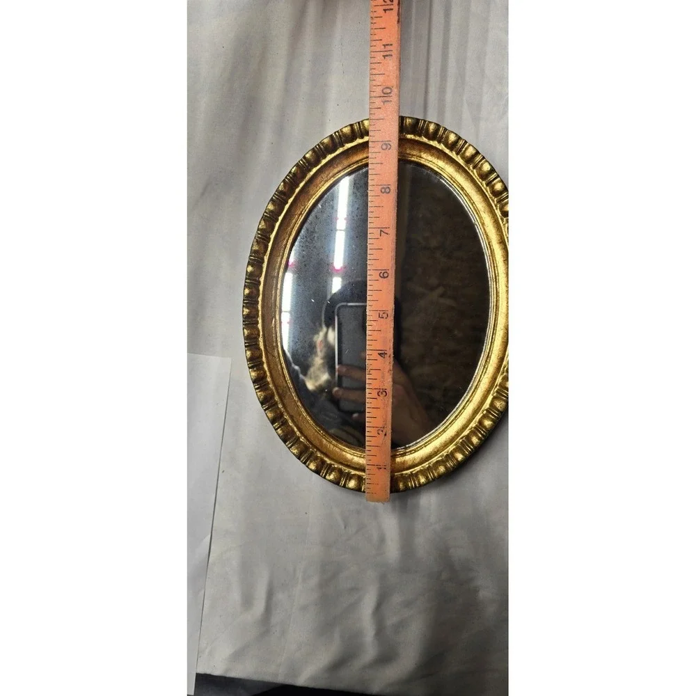 Vintage Or Antique Oval Wall Mirror with An Ornate Gold Gilt Frame